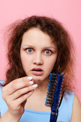 portrait of a woman in blue t-shirts comb with hair emotions isolated background unaltered