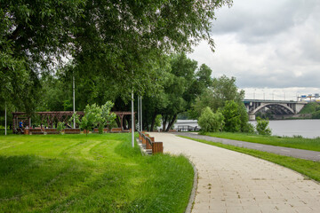 Pedestrian and bicycle roads on the embankment in the Kapotnya district, view of the Moskva River and Besedinsky Bridge