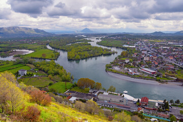 Meanders of rivers. Albania, Shkoder city. View of Drin river on cloudy spring day