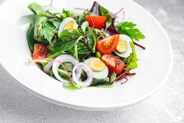 easter salad quail egg holiday snack tomato, lettuce mix leaves healthy meal food on the table copy space food background rustic top view 