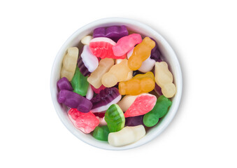 Various multicolored wine gums candies in white ceramic bowl on white background.