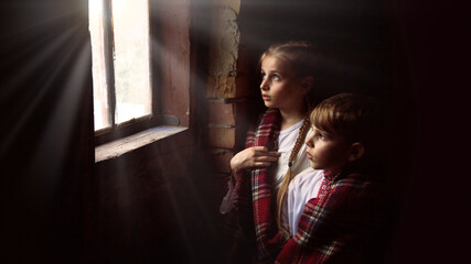 Children stand at the window