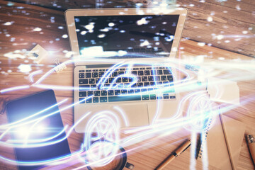 Auto pilot hologram drawing over computer on the desktop background. Top view. Double exposure. Tech concept.