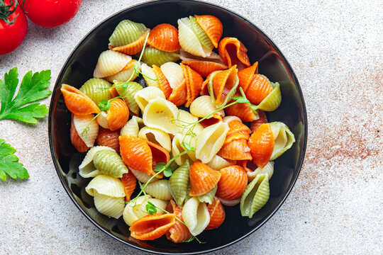 pasta conchiglie colorful mix Italian food durum wheat semolina flour semola healthy meal food snack on the table copy space food background rustic top view