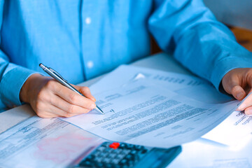 Detail on business woman hands putting signature and control official paper bill or new contract....