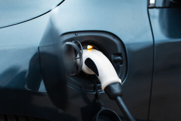 Fototapeta na wymiar Close-up of plug-in electric car on charging station.