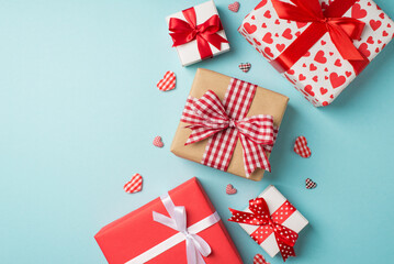 Top view photo of valentine's day decorations gifts present boxes and hearts on isolated pastel blue background with copyspace