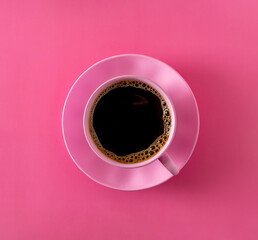 Obraz na płótnie Canvas pink cup with black coffee and pink saucer on pink background,