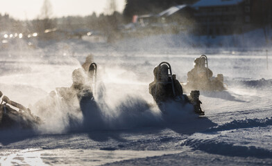 Karting racing action in winter on a lake ice in Tahko, Finland. Motorsports recreation activity.