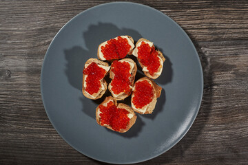 sandwiches with red caviar on white bread with butter. view from above