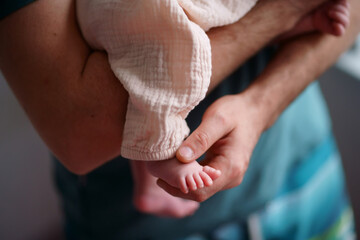 dad with baby in his arms holding her legs. High quality photo