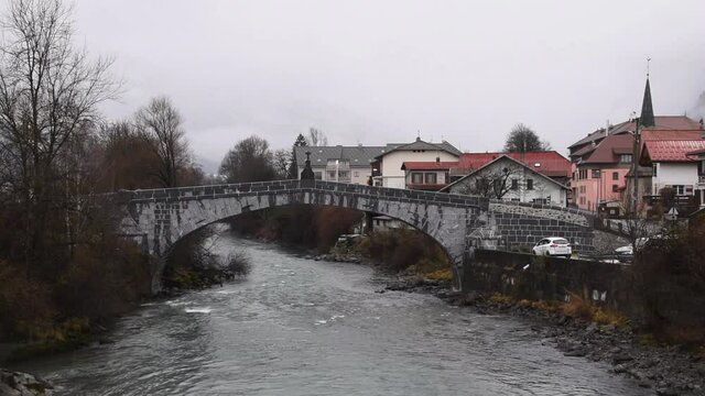 Winter landscape with Arve river and old bridge in the French town of Sallanches