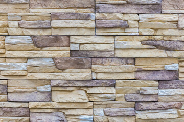 Texture of decorative facing covering made of large bricks, background. Building materials.