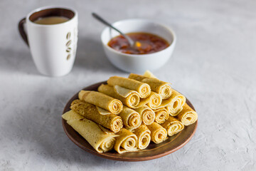 pancakes on a gray concrete background. side view, close-up, french tea party.