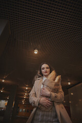 girl walks around the city French baguette in her hands