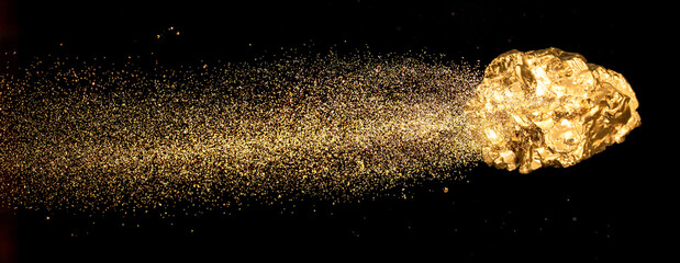 Piece of gold or golden nugget with visible gold shining comet tail ath the dark background.