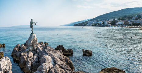 The Maiden with the Seagull. The statue is the symbol of  Opatij, Croatia. Beautiful panoramic view...