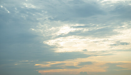 The sky, with clouds, and the light from the orange sun, was about to set off.
