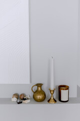 Candle in a golden candlestick on a shelf Decorative decorations for the interior of the house