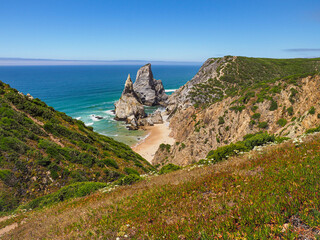 Beautiful Portuguese landscape. Blue Atlantic Ocean and amazing steep cliffs. Ursa Beach or Praia...