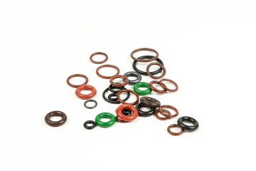 Hydraulic and pneumatic o-rings in different sizes and colors, on a white background. Various seals for plumbing. Sealing rings for hydraulic connections.