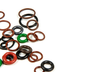 Hydraulic and pneumatic o-rings in different sizes and colors, on a white background. Various seals for plumbing. Sealing rings for hydraulic connections.