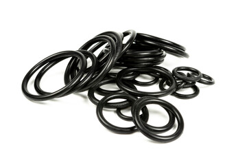 Hydraulic and pneumatic o-rings in black in different sizes on a white background. Various seals...