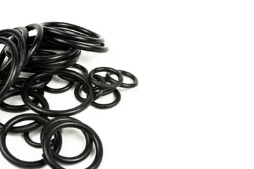 Black hydraulic and pneumatic o-rings in different sizes on a white background. O-rings for hydraulic connections. Rubber seals for sanitary ware. Copy space