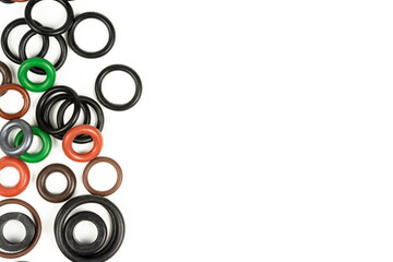 hydraulic and pneumatic sealing rings in different sizes and colors, on a white background. Sealing rings for hydraulic connections. Rubber seals for plumbing. copy space
