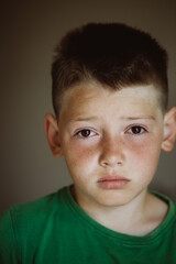 Adorable funny sleepy blond boy just wake up and looking frustrated after sleep