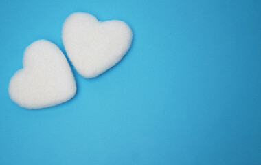 Valentine's Day card. Valentine's Day background. Two shaggy white Valentine hearts blue background. Copy space. Top view.