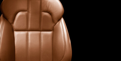 Modern luxury car brown leather interior. Part of orange leather car seat details with stitching....
