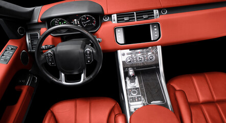 Red luxury modern car Interior. Steering wheel, shift lever and dashboard. Detail of modern car...