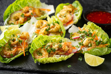 Lettuce wraps loaded with Spicy prawn, shrimp and rice vermicelli noodles, Asian style finger party food