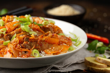 Korean Stir Fried pork belly kimchi with rice and spring onion. Asian food style