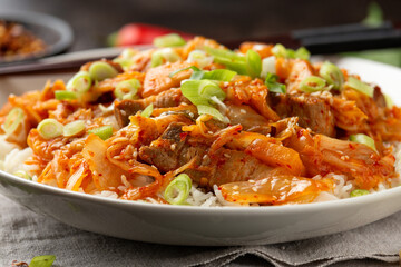 Korean Stir Fried pork belly kimchi with rice and spring onion. Asian food style