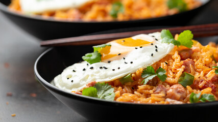 Kimchi fried rice with fried egg and bacon. Korean food
