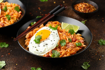Kimchi fried rice with fried egg and bacon. Korean food