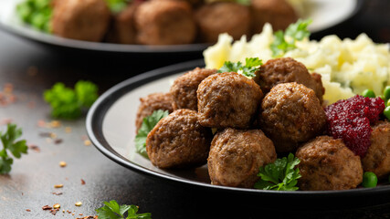 Homemade Swedish Meatballs with cranberry relish Sauce, potato mash and peas