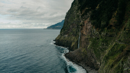 Beautiful scenic view of the cliffs over the Atlantic Ocean with blue sea green landscape in Madeira island