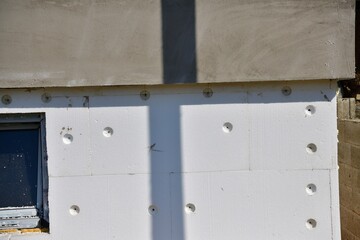 The house during the insulation of the wall with polystyrene