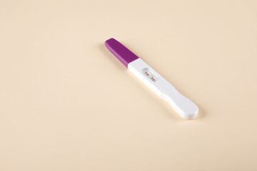 Pregnancy test kit with positive results isolated on paper background