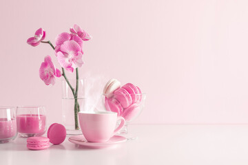 Beautiful flowers composition with pink orchid flower, steaming cup coffee or hot drink and...