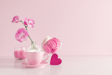 Beautiful flowers composition with pink orchid flower, steaming cup coffee or hot drink and...