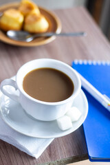 closeup cup of coffee note and pen business office notebook table work drink milk cappuccino latte caffeine espresso beverage evelopment working computer laptop nobody