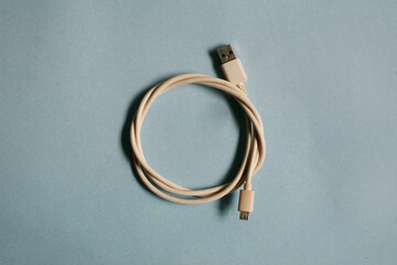 white usb cable isolated on blue background