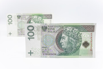 One hundred zloty - Polish banknote. Polish currency on a white background arranged in a pattern. Illustrates cash flow and business