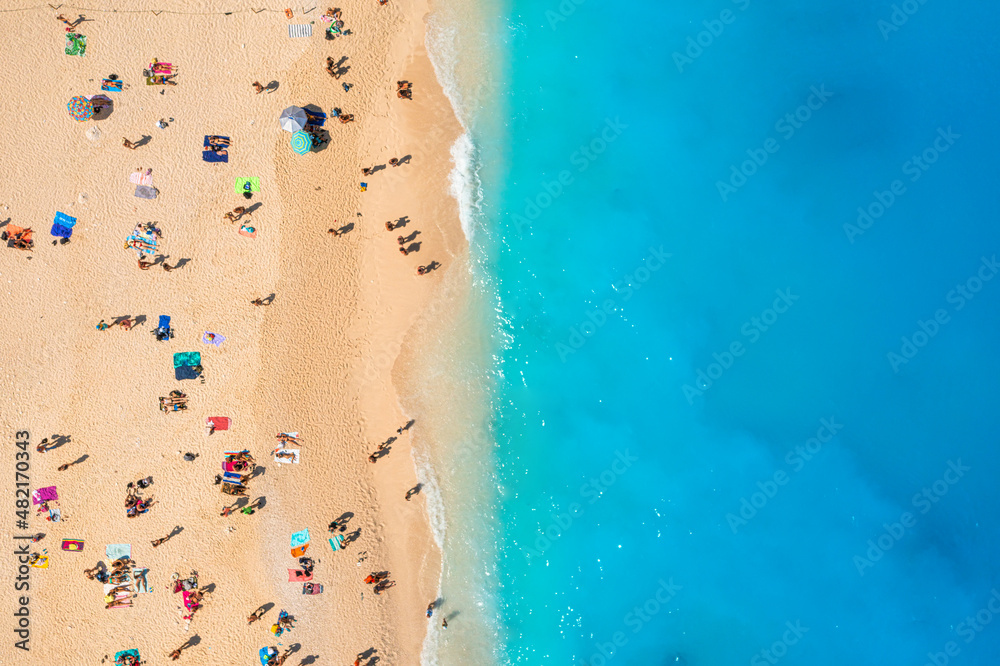 Wall mural people relaxing on the beach during their vacation. blue sea water. summer landscape from drone. aer - Wall murals