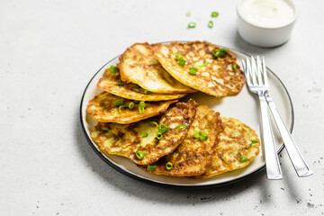 Zucchini pancakes with yogurt sauce. Space for text.