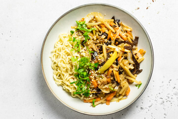 Teriyaki vegetable stir fry, noodles in a bowl. Top view, copy space.